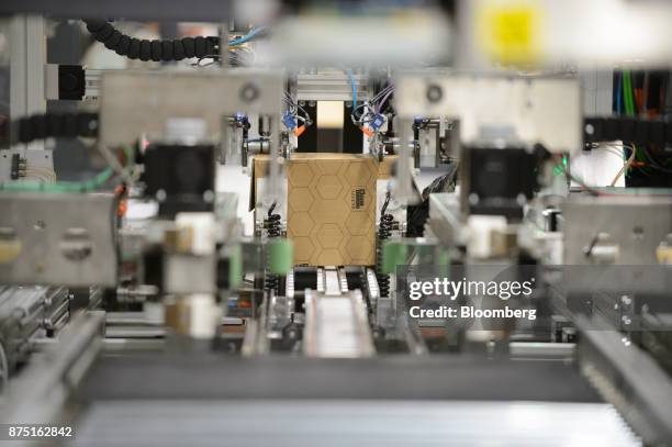 Cardboard box moves through the Neopost SA CVP-500 automated packing system at the Yamato Holdings Co. Atsugi Gateway distribution center in Aikawa,...