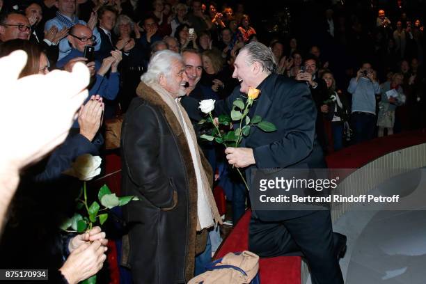 Gerard Depardieu acknowledges the applause of the audience and gives flowers to Jean-Paul Belmondo and Antoine Dulery at the end of "Depardieu Chante...
