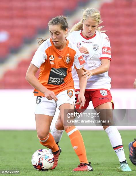 Celeste Boureille of the Roar is challenged by Makenzy Doniak of Adelaide United during the round four W-League match between Brisbane and Adelaide...