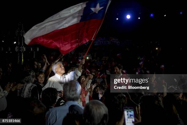 Presidential candidate Sebastian Pinera waves a Chilean national flag during a campaign rally in Santiago, Chile, on Thursday, Nov. 16, 2017....