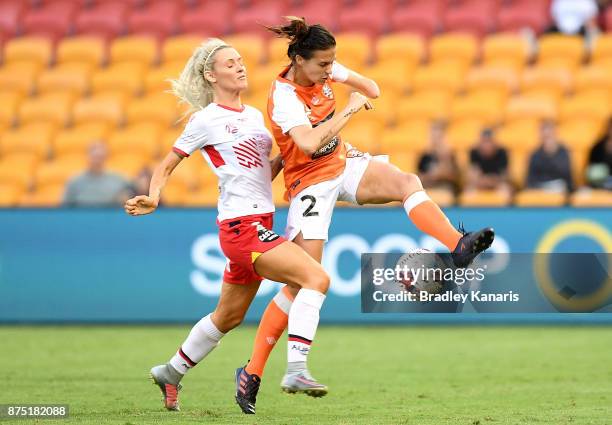 Carson Pickett of the Roar and Adriana Jones of Adelaide United challenge for the ball during the round four W-League match between Brisbane and...