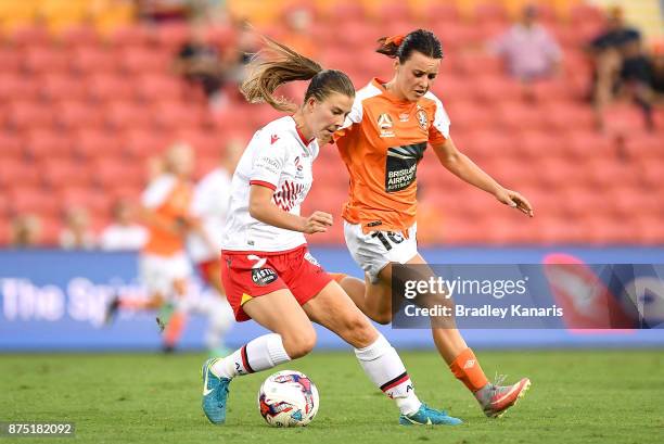 Emily Hodgson of Adelaide United is challenged by Hayley Raso of the Roar during the round four W-League match between Brisbane and Adelaide at...