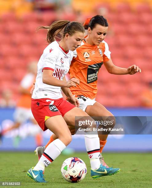 Emily Hodgson of Adelaide United is challenged by Hayley Raso of the Roar during the round four W-League match between Brisbane and Adelaide at...