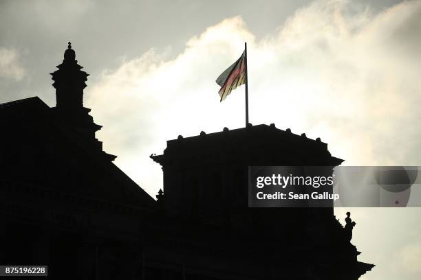 German flag flies over a corner tower of the Reichstag, seat of the Bundestag, the morning after leaders of the four leading parties failed to reach...