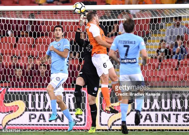 Avram Papadopoulos of the Roar gets the ball past goalkeeper Eugene Galekovic of Melbourne City to score a goal during the round seven A-League match...