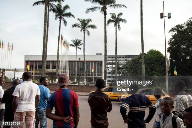 People look at the damaged building of Cameroon's parliament on November 17, 2017 in Yaounde, after a fire swept through the main building overnight,...