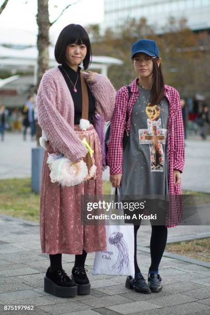 Misa and Aki stop for a quick fashion snap leaving Design Festa vol. 46. Misa is wearing a Ogucreeeeem pink knit cardigan, Availu pink skirt, black...