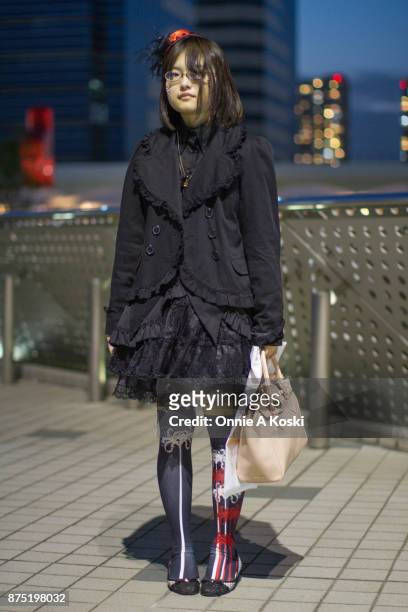 Mio, wearing a victorian gothic Lolita black dress and jacket, floral pattern red, white and black socks by komagire, a purple crystal necklace with...
