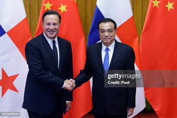 Chinese Premier Li Keqiang shakes hands with Panama's President Juan Carlos Varela before their meeting at the Great Hall of the People on November...