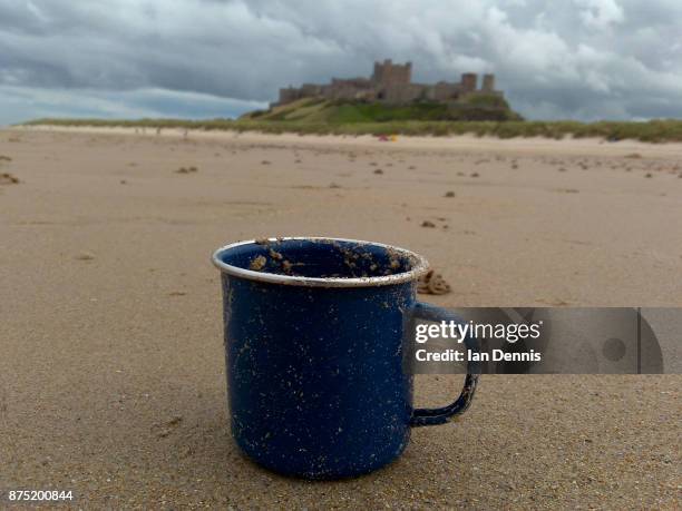 bamburgh castle in northumberland, england with blue mug - bamburgh castle stock pictures, royalty-free photos & images