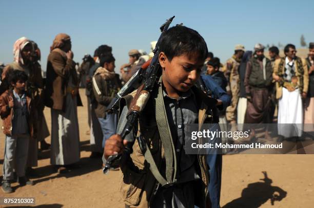 Child Houthi fighter performs the Yemeni traditional Barra dance as part of a tribal gathering staged to reinforce front lines where they are...