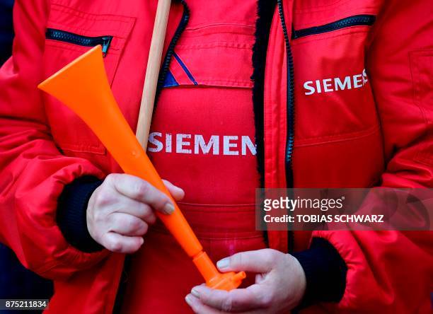 An employee of German industrial conglomerate Siemens demonstrates at Siemens' famed "Dyanomowerk" site in Berlin to protest against restructuring...