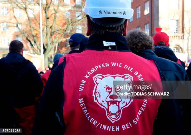 An employee of German industrial conglomerate Siemens wears a vest reading "We fight like bears" while demonstrating at Siemens' famed "Dyanomowerk"...