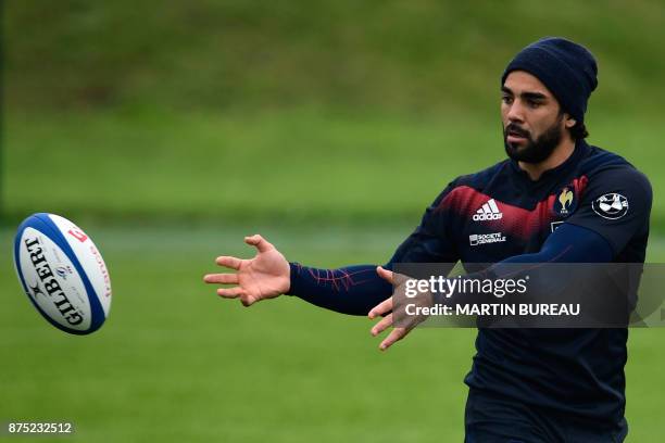 French rugby union national team wing Yoann Huget passes the ball during a captain's run session in Marcoussis near Paris on November 17 on the eve...