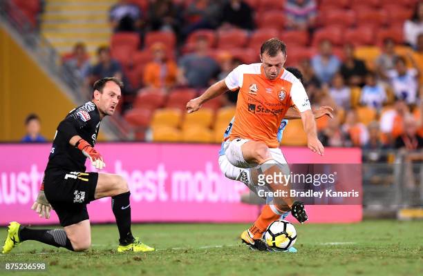 Avram Papadopoulos of the Roar gets past goalkeeper Eugene Galekovic of Melbourne City to score a goal during the round seven A-League match between...