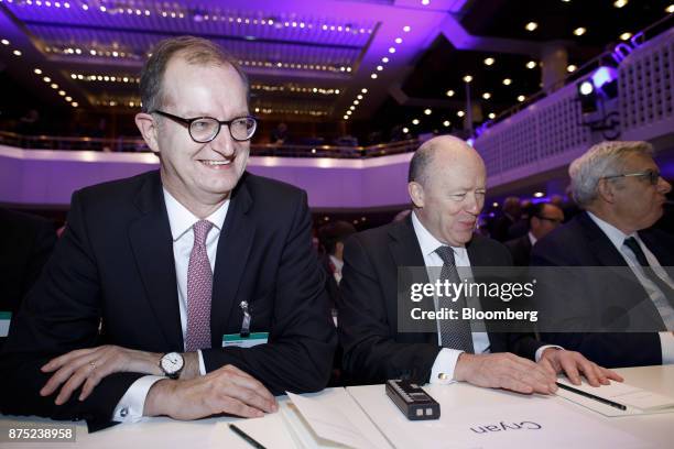 Martin Zielke, chief executive officer of Commerzbank AG, left, and John Cryan, chief executive officer of Deutsche Bank AG, react during the...