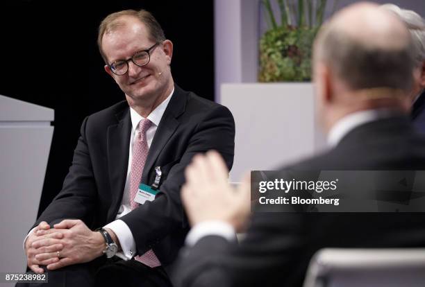 Martin Zielke, chief executive officer of Commerzbank AG, left, reacts during a panel discussion at the European Banking Congress on the final day of...