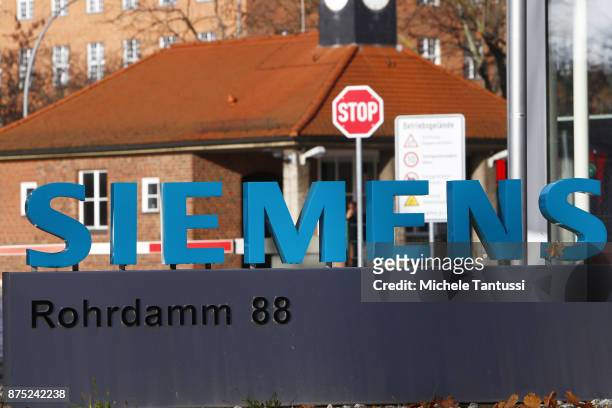 The Company Logo hangs in front of the Siemens dynamo factory on November 17, 2017 in Berlin, Germany. Siemens announced the day before it will be...