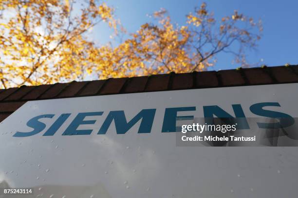 The Company Logo hangs in front of the Siemens dynamo factory on November 17, 2017 in Berlin, Germany. Siemens announced the day before it will be...