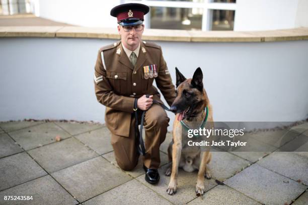 Mali, a Belgian Malinois British Military Working Dog wearing the PDSA Dickin Medal and his handler Corporal Daniel Hatley pose for a photograph at...