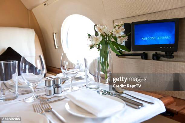 a luxury dinner for two onboard a jet. - billionaire stock pictures, royalty-free photos & images