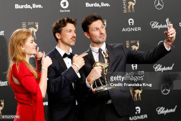 Palina Rojisnki, Florian David Fitz and Simon Verhoeven pose with an award at the Bambi Awards 2017 winners board at Stage Theater on November 16,...