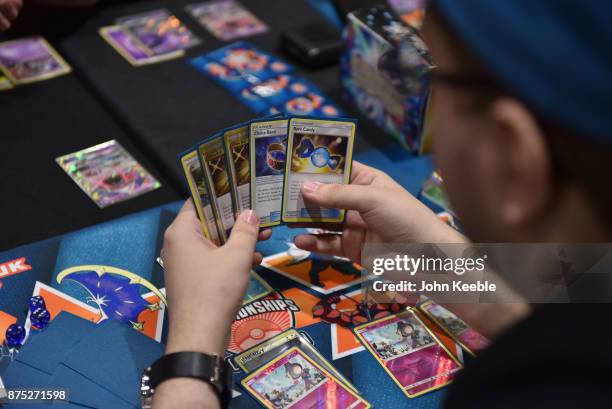 Competitor checks their hand at the Pokemon European International Championships at ExCel on November 17, 2017 in London, England. Thousands of...