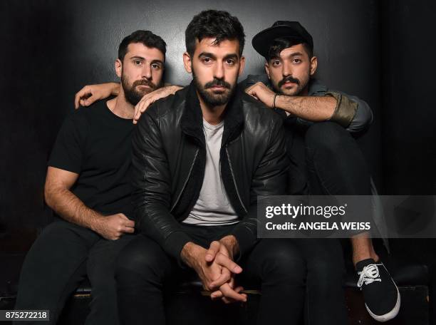 Musicians Haig Papazian, Carl Gerges and Hamed Sinno of Mashrou' Leila pose for a picture on November 1, 2017 in New York. The symbol of solidarity...