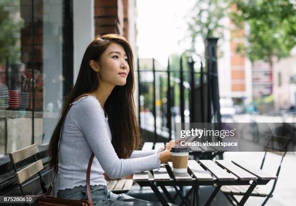 young woman with smartphone - beautiful asian student stock pictures, royalty-free photos & images