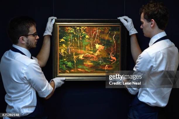 Two gallery assistants pose with "The Goldfish Pool at Chartwell" , the last painting created by former British Prime Minister Winston Churchill, at...