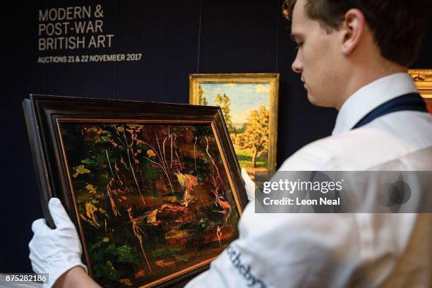 Gallery assistant poses with "The Goldfish Pool at Chartwell" , the last painting created by former British Prime Minister Winston Churchill, at...