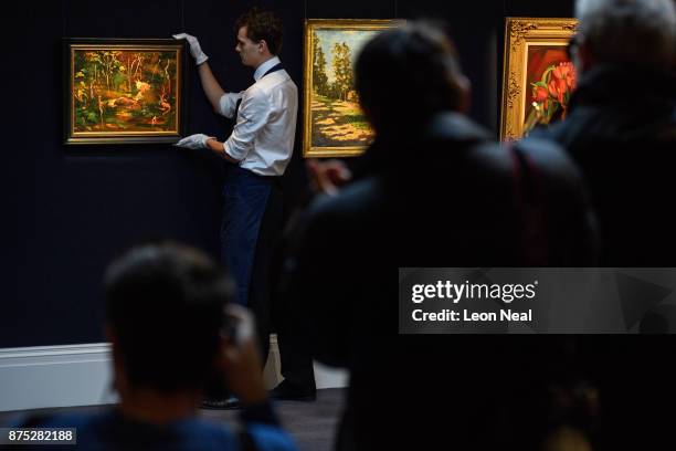 Gallery assistant poses with "The Goldfish Pool at Chartwell" , the last painting created by former British Prime Minister Winston Churchill, at...