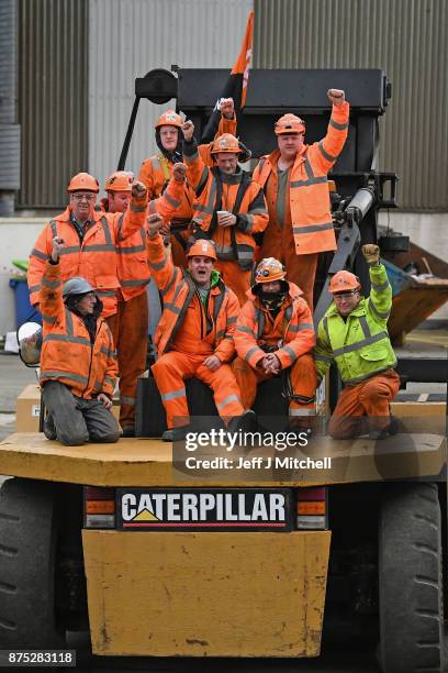 Group of workers sit on a Catterpillar, at the entrance gates to the Burntisland yard of engineering company BiFab, where staff are continuing a...