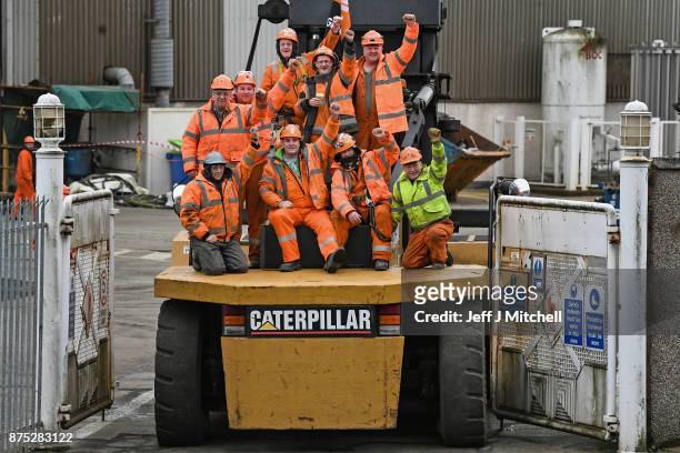 Group of workers sit on a Catterpillar, at the entrance gates to the Burntisland yard of engineering company BiFab, where staff are continuing a...