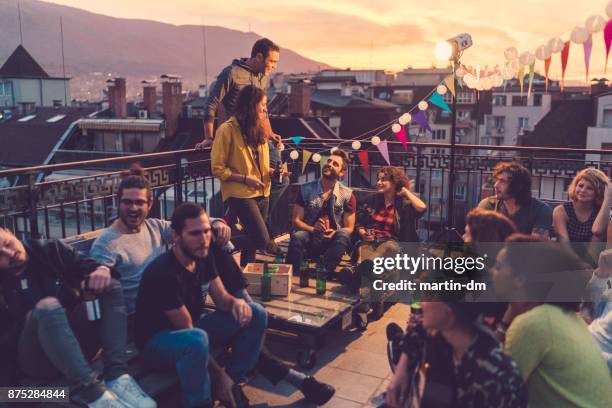 social gathering on the rooftop - reunion social gathering stock pictures, royalty-free photos & images