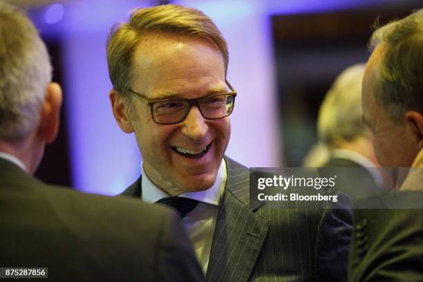 Jens Weidmann, president of the Deutsche Bundesbank, reacts while standing with attendees during the European Banking Congress on the final day of...