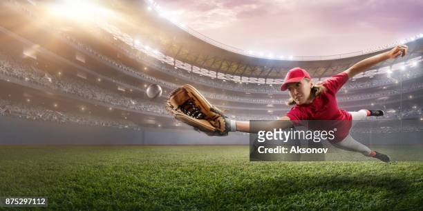 softball female player on a professional arena - softball glove stock pictures, royalty-free photos & images