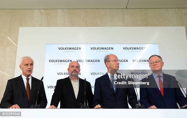 From left, Matthias Mueller, chief executive officer of Volkswagen AG, speaks as Bernd Osterloh, works council chief at Volkswagen AG, Hans Dieter...