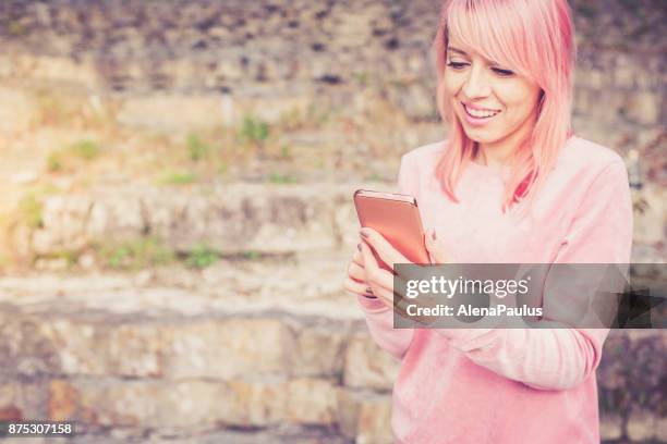 millennial pink young woman - millennial pink stock pictures, royalty-free photos & images