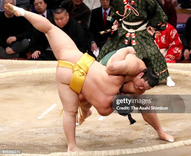 Okinoumi throws Endo to win during day six of the Grand Sumo Kyushu Tournament at Fukuoka Convention Center on November 17, 2017 in Fukuoka, Japan.