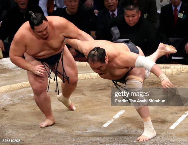 Asanoyama throws Aminishiki to win during day six of the Grand Sumo Kyushu Tournament at Fukuoka Convention Center on November 17, 2017 in Fukuoka,...