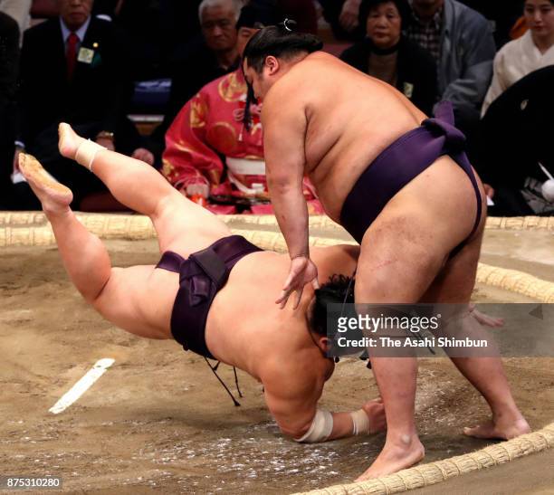 Daiamami throws Takekaze to win during day six of the Grand Sumo Kyushu Tournament at Fukuoka Convention Center on November 17, 2017 in Fukuoka,...