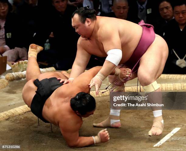 Takarafuji throws Chiyonokuni to win during day six of the Grand Sumo Kyushu Tournament at Fukuoka Convention Center on November 17, 2017 in Fukuoka,...