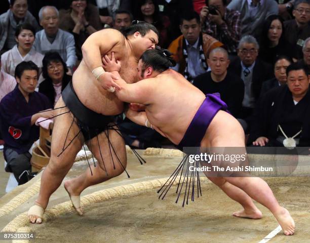 Takakeisho pushes ozeki Takayasu out of the ring to win during day six of the Grand Sumo Kyushu Tournament at Fukuoka Convention Center on November...