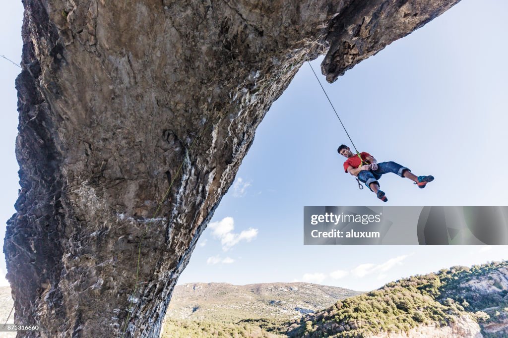 Rock climber rappelling down