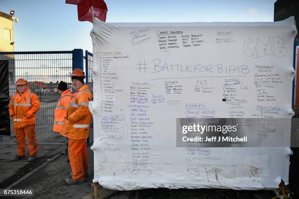 Group of workers gather at the entrance gate to the Methil yard of engineering company BiFab, where staff are continuing a work-in despite the firm...