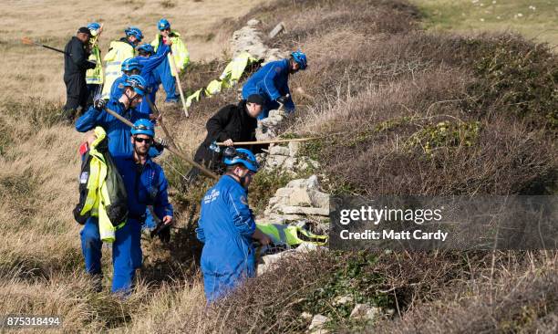 Police and other search and rescue agencies perform a search in the open space above the coast near to Swanage in Dorset as they continue to...