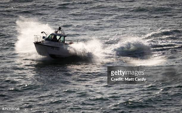 Boat is pictured as police and other search and rescue agencies perform a search in the open space above the coast near to Swanage in Dorset as they...