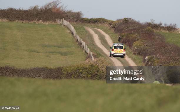 Police patrol a track above the coast near to Swanage in Dorset as they continue to investigate the disappearance of Gaia Pope on November 17, 2017...