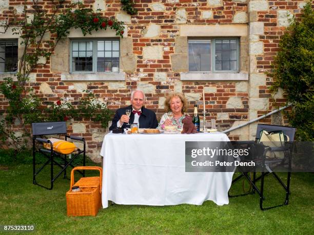 Picnic on the lawn at Glyndebourne during the interval at the opera. Glyndebourne is an English country house, the site of an opera house that, since...